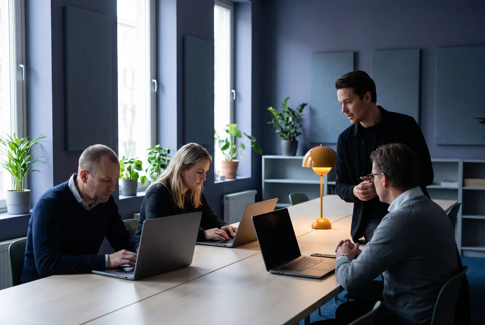The staff of a customer’s organisation working together at a table.